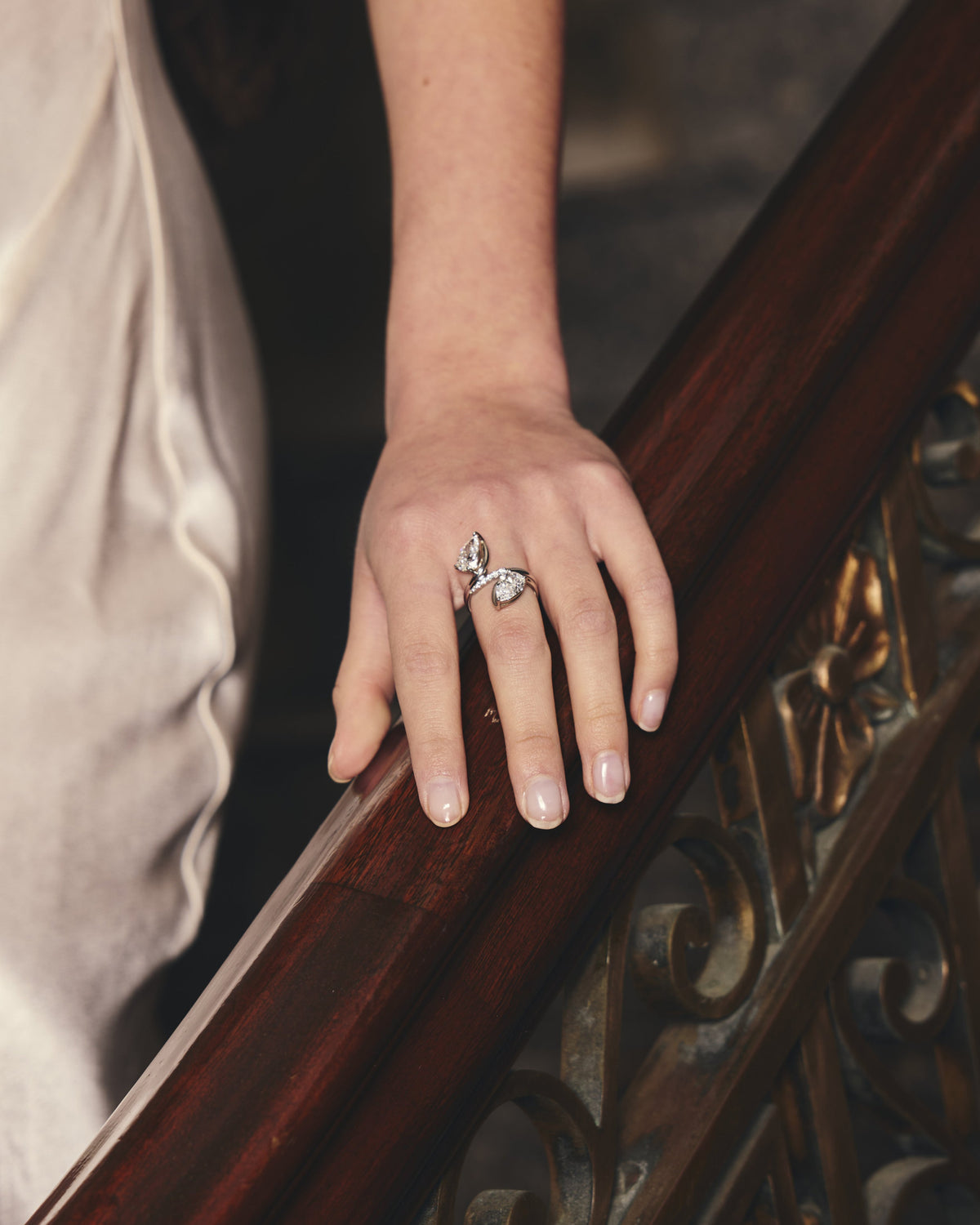Hand with a ring on a wooden railing