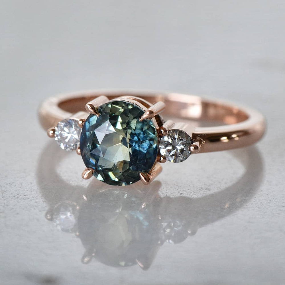 A Sapphire Diamond Ring placed on a white surface