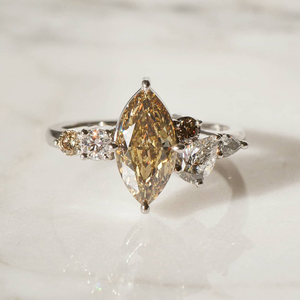 A close-up of Marquise cut Diamond Ring placed atop a shiny surface