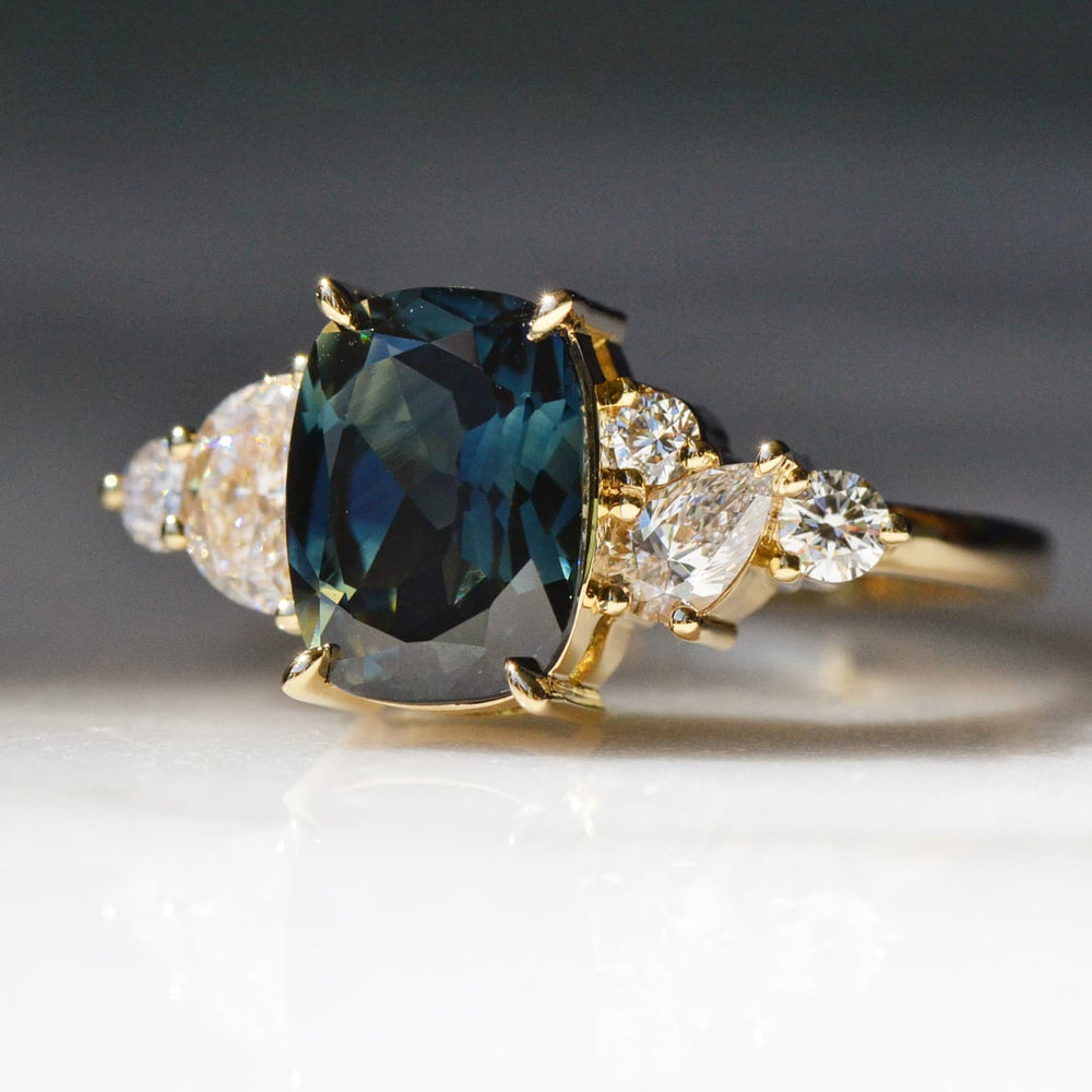 A Sapphire Diamond Ring placed on a white surface