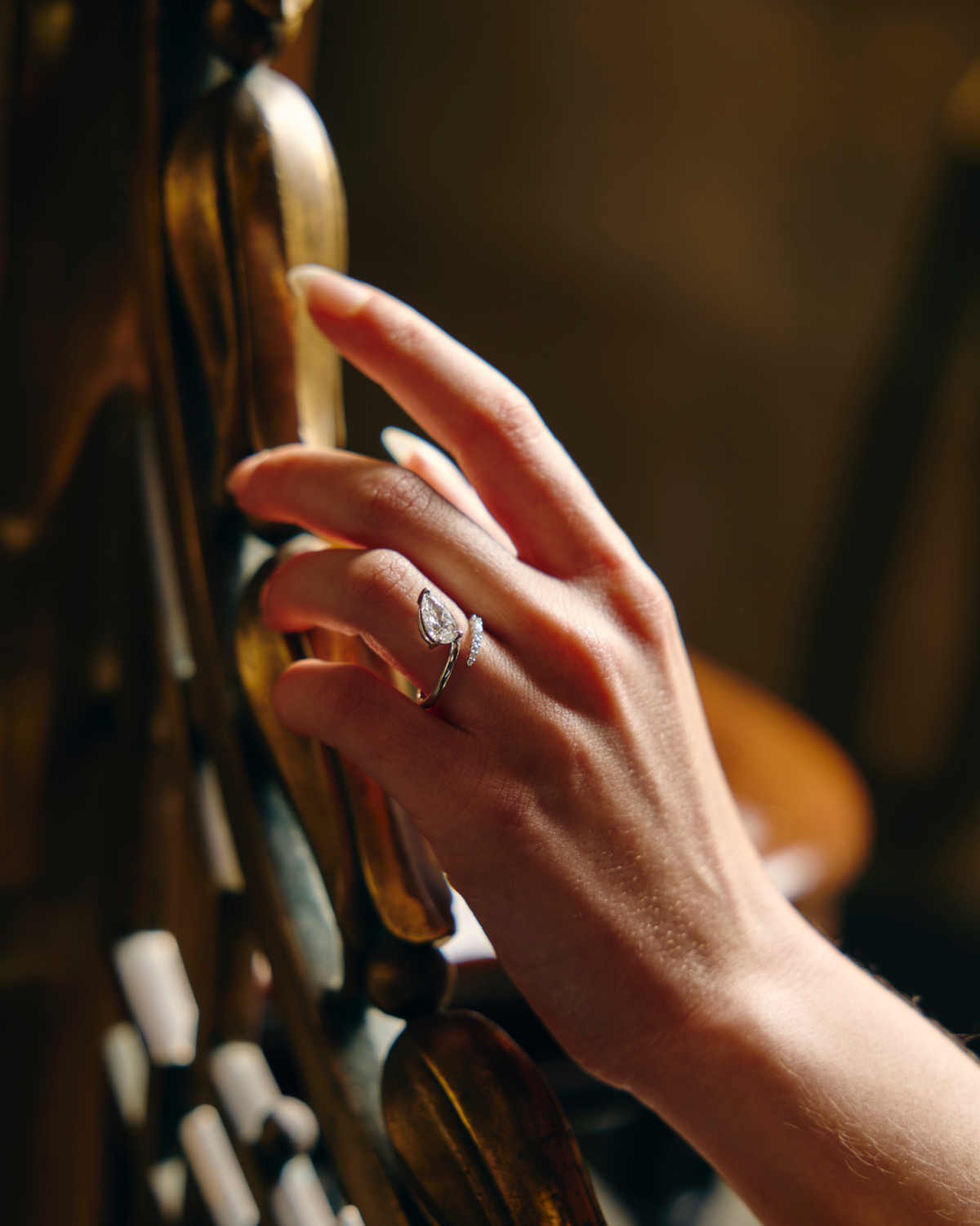 Hand with a ring on a staircase rail against a blurred background