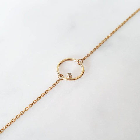 A stunning 9ct Gold Choker Chain placed on the white shiny surface.